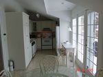Fully equipped kitchen w/doors to back deck