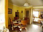 View of dinette from kitchen, overlooking open concept living and dining area.