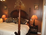 Luxury 4 Poster Bed with soothing decor to come back to after your day touring the wineries.